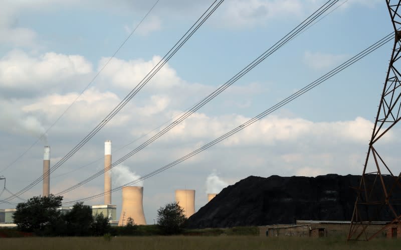 A heap of coal is seen beneath power lines near an Eskom power station in Duhva