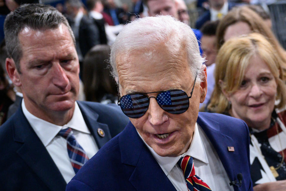 TOPSHOT - US President Joe Biden wears sunglasses given to him by supporters after speaking on the PACT Act, which expands coverage for veterans exposed to toxic substances, at the Westwood Park YMCA in Nashua, New Hampshire, on May 21, 2024. (Photo by Mandel NGAN / AFP) (Photo by MANDEL NGAN/AFP via Getty Images)