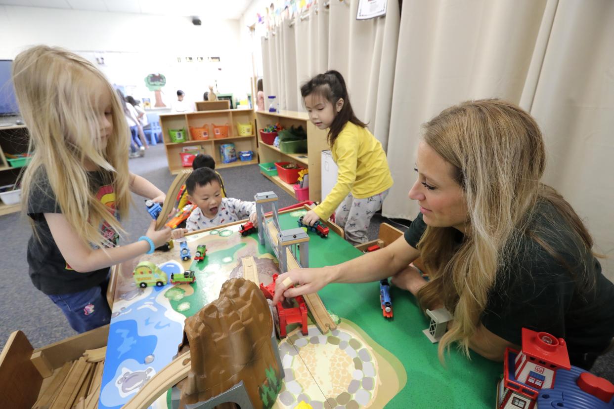 Teacher Amber Krueger helps students work on problem-solving skills during their 4K class at Foster Elementary School in Appleton.