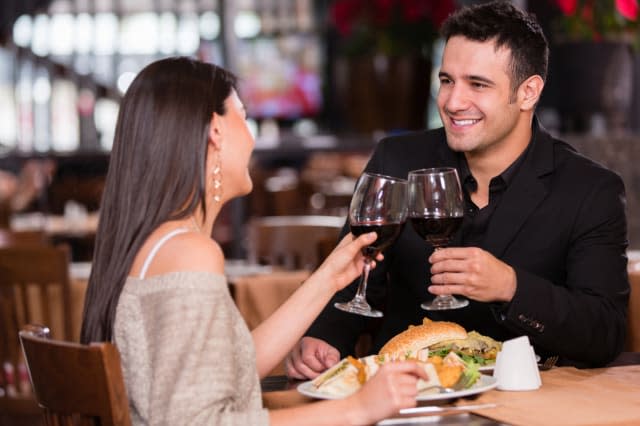 Couple having dinner at a restaurant and making a toast