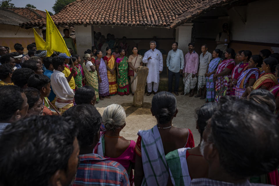 Salkhan Murmu, a former lawmaker and community activist, centre in white, speaks to tribespeople during an awareness campaign to demand recognition of Sarna Dharma as a religion in village Guduta, in the eastern Indian state of Odisha, Oct. 21, 2022. Murmu, who also adheres to Sarna Dharma, is at the center of the protests pushing for government recognition of his religion. His sit-in demonstrations in several Indian states have drawn crowds of thousands. (AP Photo/Altaf Qadri)