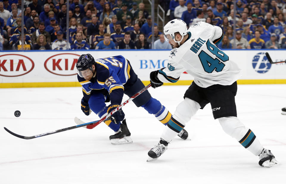 St. Louis Blues defenseman Colton Parayko (55) tries to block the shot of San Jose Sharks center Tomas Hertl (48), of the Czech Republic, during the second period in Game 4 of the NHL hockey Stanley Cup Western Conference final series Friday, May 17, 2019, in St. Louis. (AP Photo/Jeff Roberson)