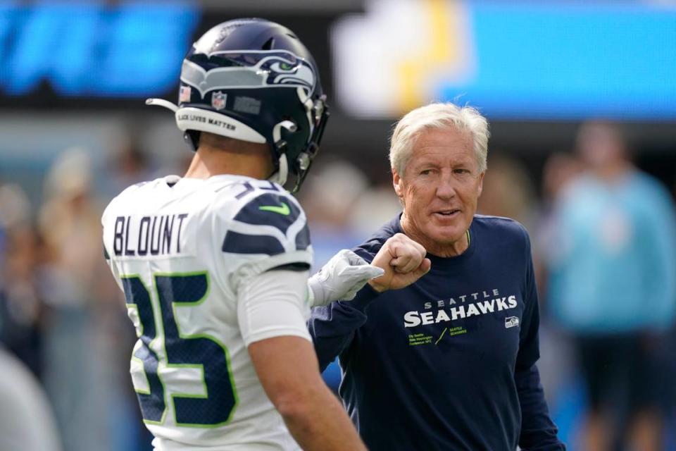 Seattle Seahawks safety Joey Blount (35) greets head coach Pete Carroll before an NFL football game against the Los Angeles Chargers Sunday, Oct. 23, 2022, in Inglewood, Calif. (AP Photo/Mark J. Terrill) Mark J. Terrill/AP