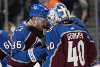 Colorado Avalanche right wing Mikko Rantanen (96) and goaltender Alexandar George (40) celebrate a 2-1 win against the Dallas Stars following an NHL preseason hockey game Wednesday, Oct. 5, 2022, in Denver. (AP Photo/Jack Dempsey)