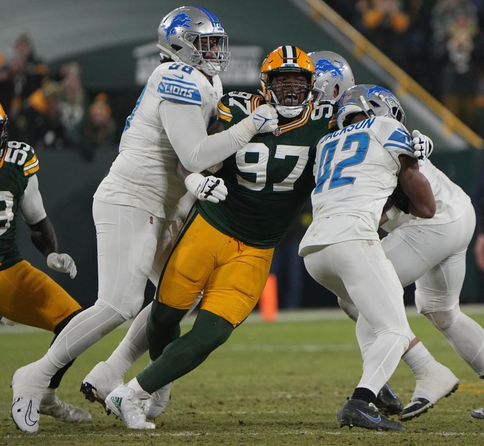 Green Bay Packers defensive tackle Kenny Clark (97) stops Detroit Lions running back Justin Jackson (42) for a 2-yard gain on Jan. 8 at Lambeau Field.