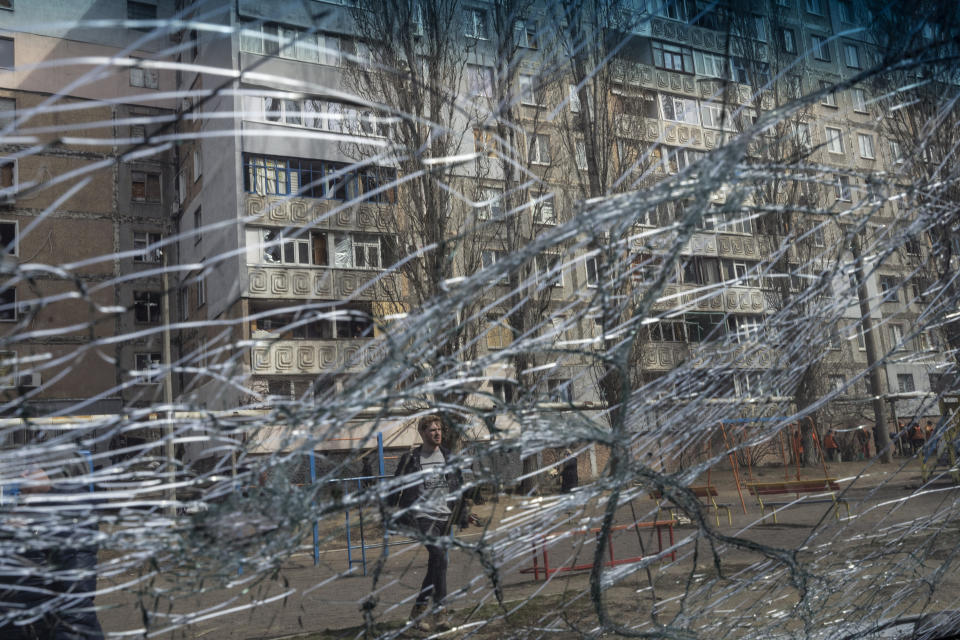 A man in seen through the front screen of a damaged car after a Russian attack on the previous night in the residential area of Mikolaiv, Ukraine, on Tuesday, March 29, 2022. Ukrainian President Volodymyr Zelenskyy says seven people were killed in a missile strike on the regional government headquarters in the southern city of Mykolayiv. (AP Photo/Petros Giannakouris)