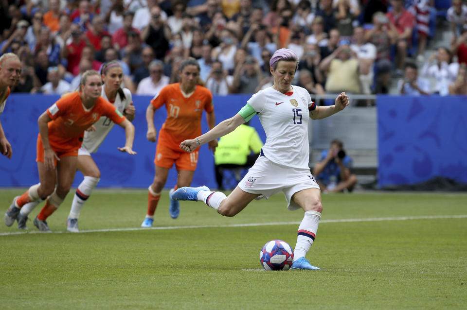 FILE - In this July 7, 2019, file photo, United States' Megan Rapinoe scores her side's opening goal from a penalty shot during the Women's World Cup final soccer match against The Netherlands at the Stade de Lyon in Decines, outside Lyon, France. Twenty players have been named to the U.S. women's soccer team that will play for a spot in the Tokyo Olympics. Coach Andonovski announced the roster for the CONCACAF Olympic qualifying tournament Friday, Jan. 17, 2020. (AP Photo/David Vincent, File)