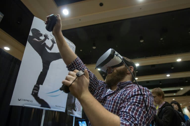 A man tries out the Taclim virtual reality system during the 2017 Consumer Electronics Show (CES) in Las Vegas, Nevada on January 3, 2017