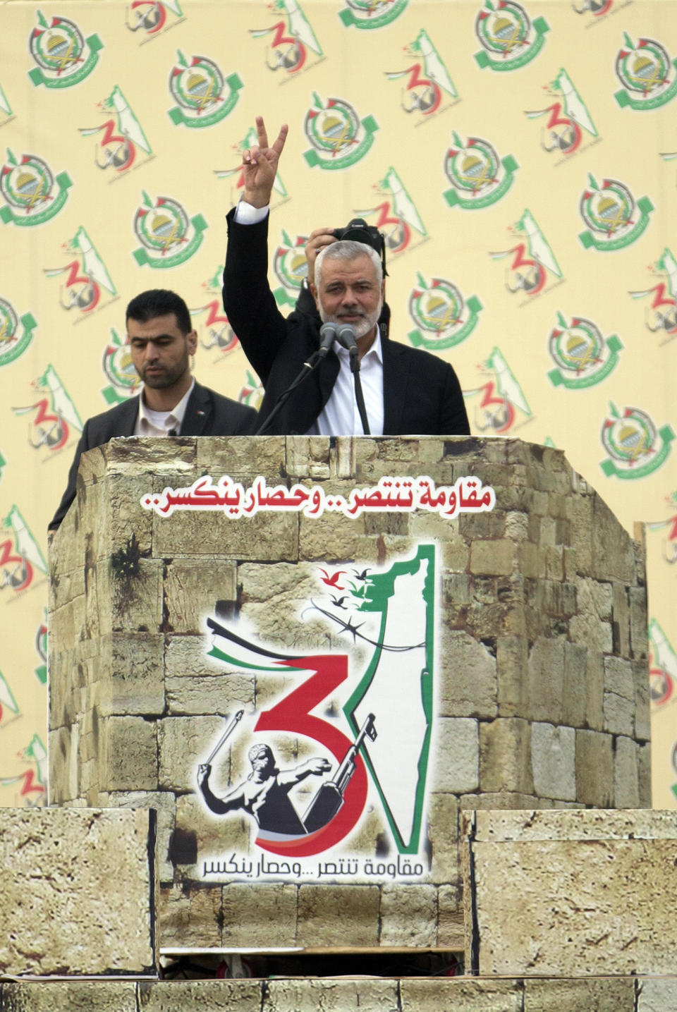 Hamas leader Ismail Haniyeh, flashes the victory sign before giving a speech during a mass rally marking the 31st anniversary of the founding of Hamas, an Islamic political party, which has an armed wing of the same name, that currently rules in Gaza, Sunday, Dec. 16, 2018, in Gaza city. (AP Photo/Khalil Hamra)