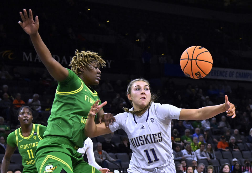 Oregon center Phillipina Kyei, left, and Washington forward Haley Van Dyke (11) vie for the ball during the second half of an NCAA college basketball game in the first round of the Pac-12 women's tournament Wednesday, March 1, 2023, in Las Vegas. (AP Photo/David Becker)
