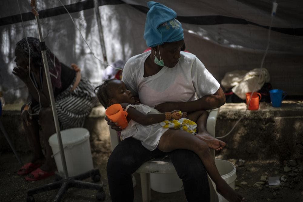 A girl with cholera symptoms is helped by her mother during her treatment at a clinic run by Doctors Without Borders in Port-au-Prince, Haiti, Thursday, Oct. 27, 2022. (AP Photo/Ramon Espinosa)