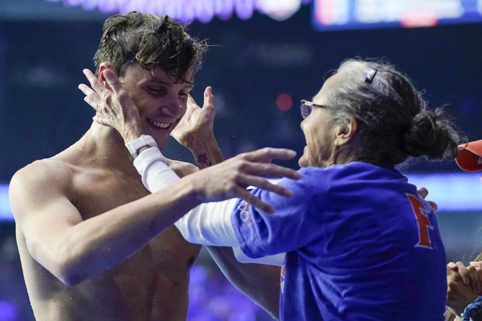 Bobby Finke gets a hug from his mother Jenny Finke after winning the men's 1500 freestyle during wave 2 of the U.S. Olympic Swim Trials on Sunday, June 20, 2021, in Omaha, Neb. (AP Photo/Jeff Roberson)