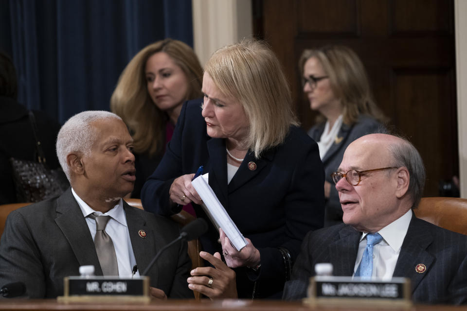 Rep. Sylvia Garcia, D-Texas, center, flanked by Rep. Hank Johnson, D-Ga., left, and Rep. Steve Cohen, D-Tenn., right, prepares for the House Judiciary Committee vote on two articles of impeachment against President Donald Trump, Friday, Dec. 13, 2019, on Capitol Hill in Washington. At rear are Rep. Debbie Mucarsel-Powell, D-Fla., left, and Rep. Madeleine Dean, D-Pa. (AP Photo/J. Scott Applewhite)