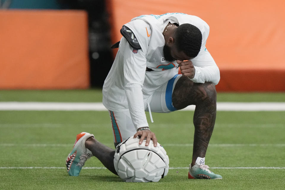 Miami Dolphins wide receiver Odell Beckham Jr. takes a moment during practice at the NFL football team's training facility, Thursday, Oct. 3, 2024, in Miami Gardens, Fla. (AP Photo/Lynne Sladky)