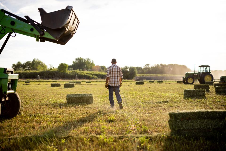 Dave Evans walks over to talk to his father, Hugh Evans, while they bale and stack hay on their property in Duchesne on Wednesday, July 27, 2022. Across the arid stretches of Utah — from Duchesne in the north to Hurricane in the south — agriculture taps into the dwindling resources of the Colorado River and its tributaries. Currently, agriculture accounts for 85 percent of Utah’s water use. The state has the highest water use per capita rate in the Colorado River Basin. | Spenser Heaps, Deseret News