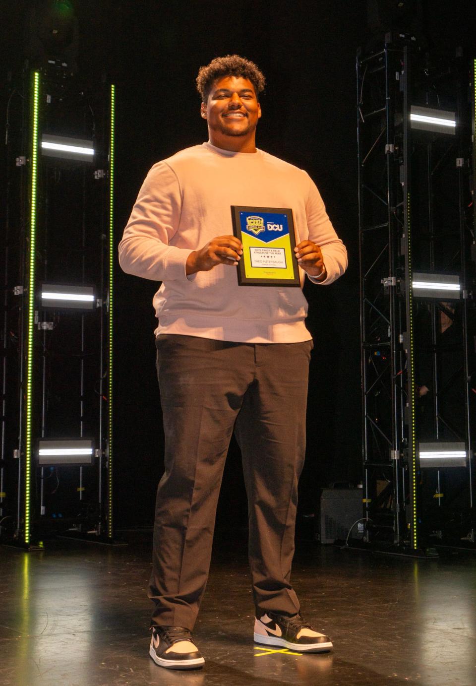 Parker Charter's Theo Puterbaugh poses with his plaque after being named T&G Hometeam Boys' Tracn and Field Athlete of the Year at Wednesday's Central Mass. High School Sports Awards at the Hanover Theatre.