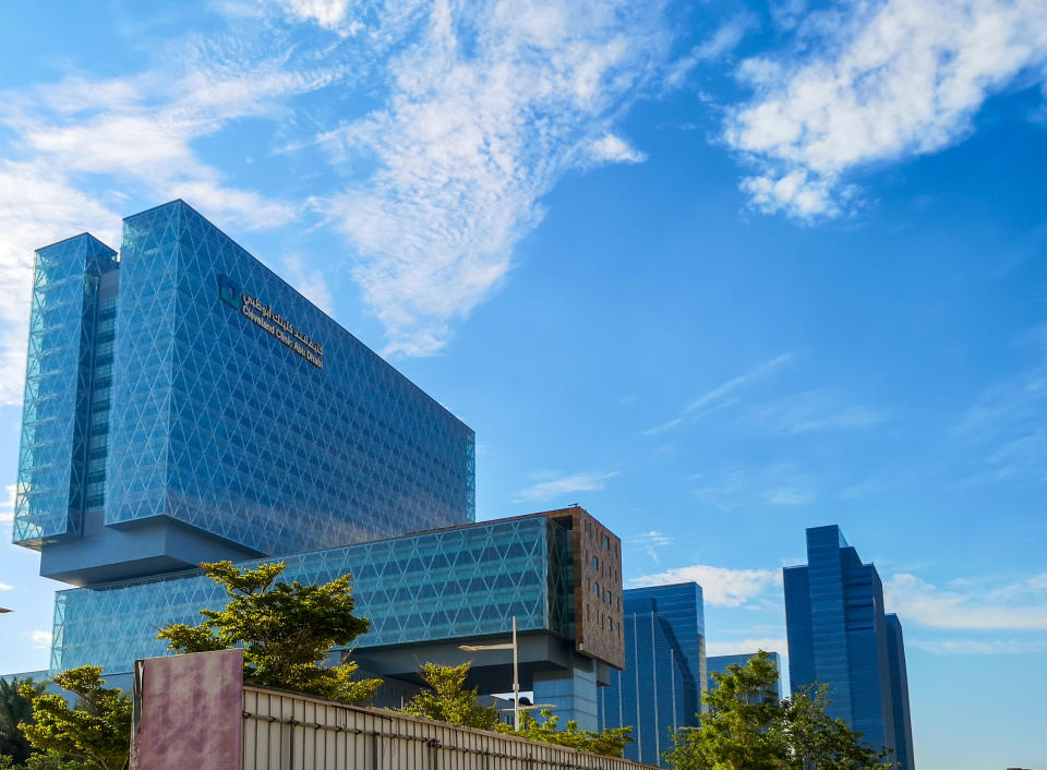 Modern hospital building surrounded by clouds - Cleveland Clinic Abu Dhabi in Al Maryah island - Abu Dhabi, UAE July 07, 2019