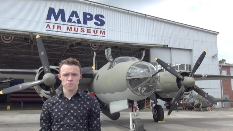 Chris Billings, the host for the documentary "Marauder Men: In Their Own Words," stands in front of the Martin B-26 Marauder World War II bomber featured in the series. The B-26 is one of only six still in existence and is on display at the MAPS Air Museum in Green.