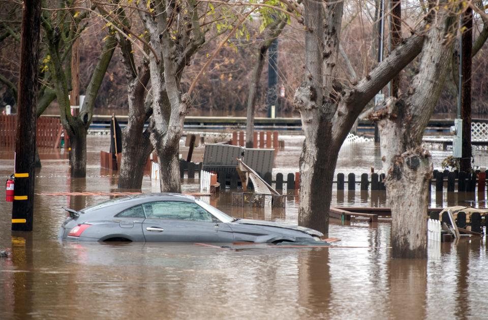 A parked car lays partially submerged on Tuesday, Jan. 3, 2023 from rising waters of the Mokelumne River at New Hope Landing RV Park near Walnut Grove. Quickly rising waters of the river forced many of more than 50 park residents to evacuate over the weekend to move their trailers to nearby Thornton. A handful of unoccupied trailers were unable to be moved.