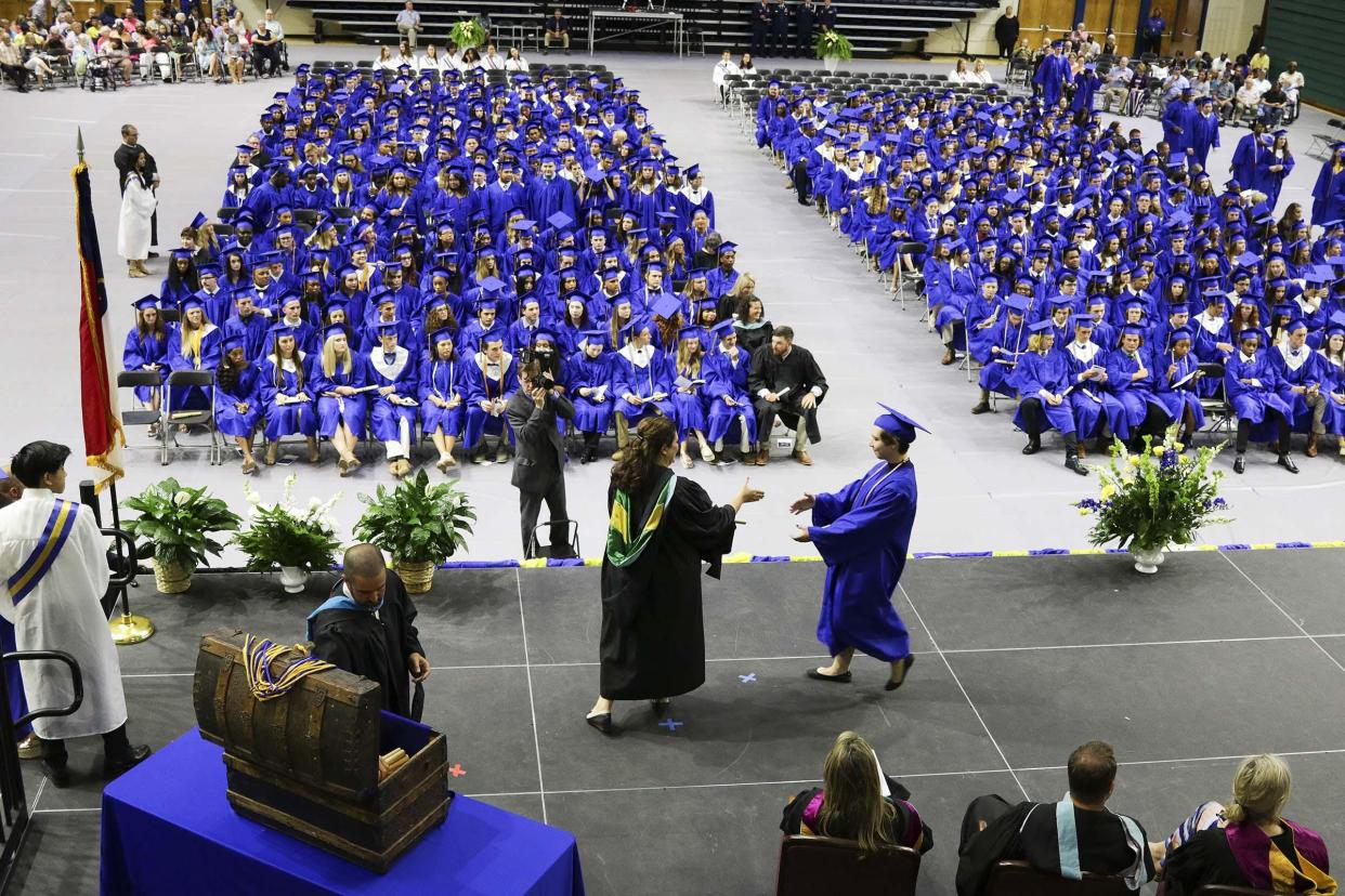 Disparities exist in the graduation rates of white students and students of color across New Hanover County's four main high schools. Graduates of Laney High receive their diplomas at a graduation ceremony on June 8, 2019, at Trask Coliseum on the campus of UNCW.