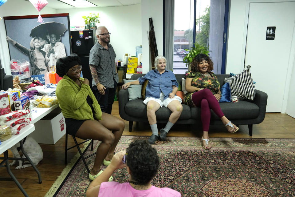 Morgan Mayfaire, a transgender man, second from left, hosts a community gathering for a food distribution event at TransSOCIAL, Thursday, July 27, 2023, in Miami. “I have friends that have retired and they’ve decided to move to retirement communities. And then, little by little, they’ve found that they’re not welcome there,” says Mayfaire. (AP Photo/Lynne Sladky)