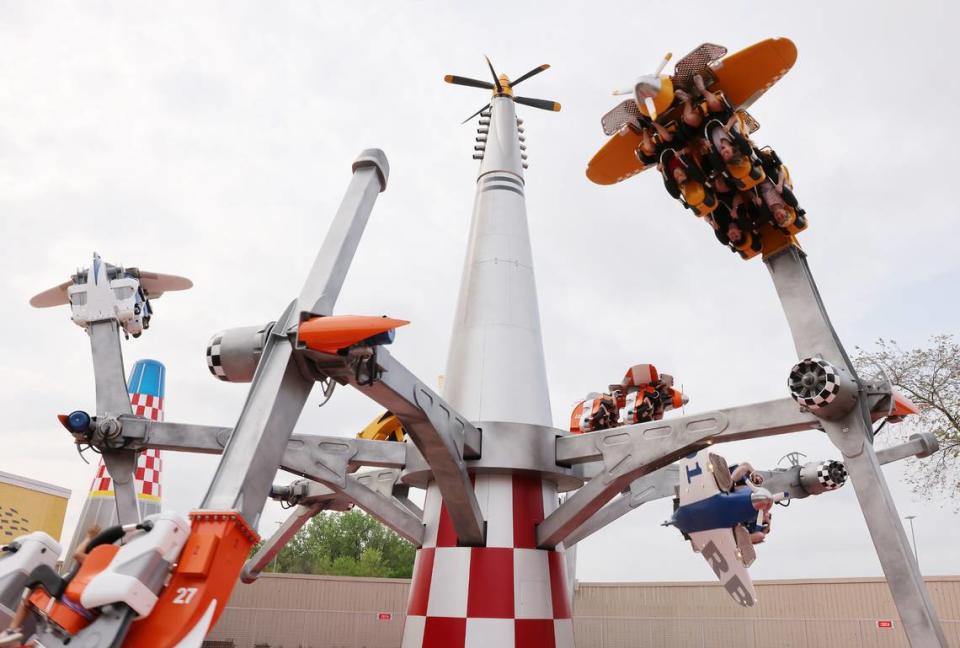 Riders scream as they fly upside down on the Air Racers attraction at Carowinds’ Aeronautica Landing.