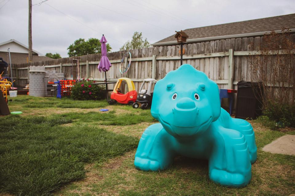 A growing number of toys and kid activities are accumulating in Kathi Barton's back yard.