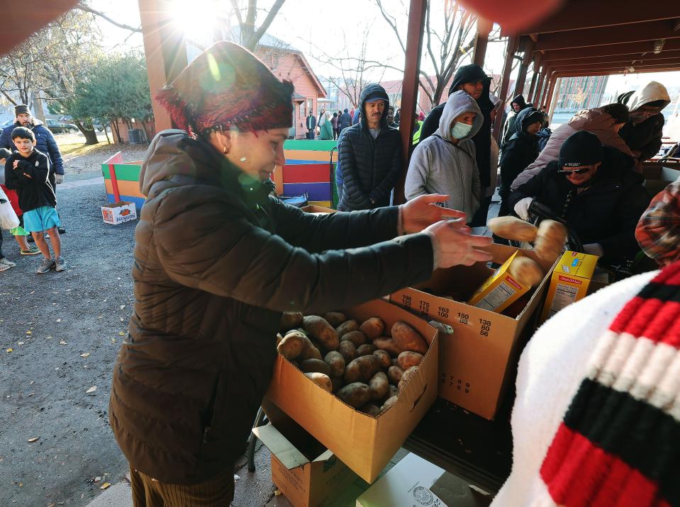 Nargiza Khaydaizova adds potatoes to boxes as Mosaic Inter-Faith Ministries hands out Thanksgiving meals in Salt Lake City on Tuesday, Nov. 21, 2023. | Jeffrey D. Allred, Deseret News