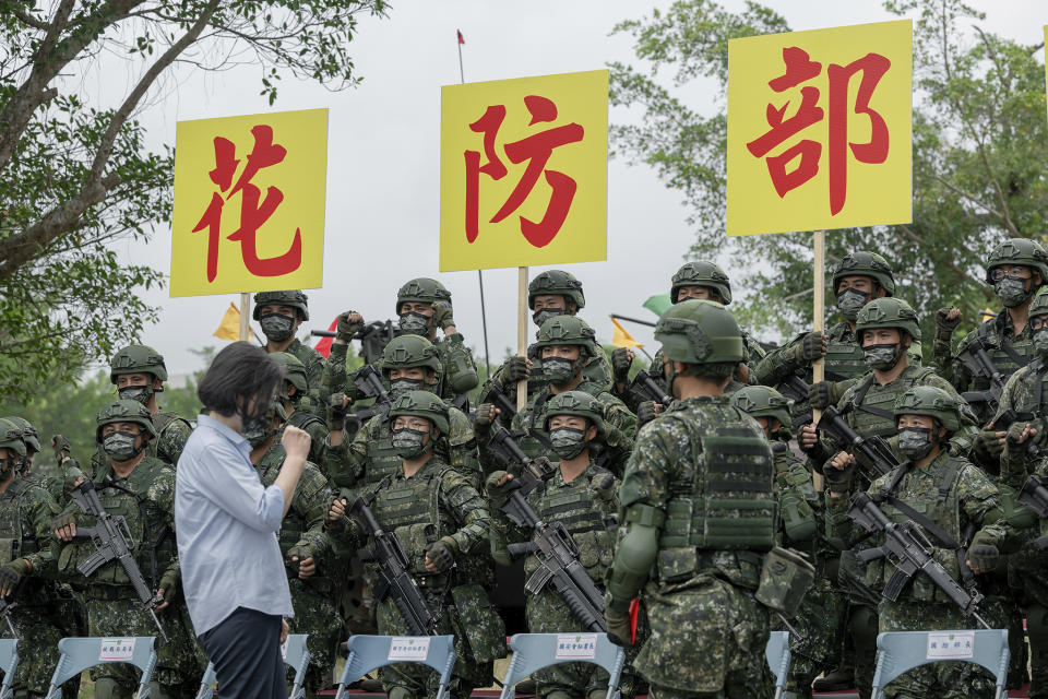 In this photo released by the Taiwan Presidential Office, Taiwan's President Tsai Ing-wen visits Taiwanese soldiers near the sign for Hualien Defense in Hualien, in eastern Taiwan on Tuesday, Sept. 6, 2022. Taiwanese President Tsai Ing-wen said Tuesday that China is conducting "cognitive warfare" by spreading misinformation in addition to its regular incursions into nearby waters and airspace intended at intimidating the self-governing island. (Taiwan Presidential Office via AP)