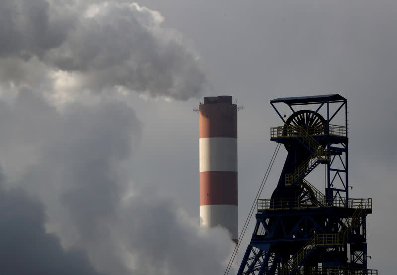 FILE PHOTO: a chimney at Laziska power station is seen behind the Boleslaw Smialy coal mine in Poland