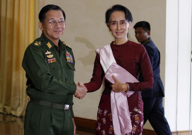 FILE PHOTO: FILE PHOTO: Senior General Min Aung Hlaing, Myanmar's commander-in-chief, shakes hands with National League for Democracy (NLD) party leader Aung San Suu Kyi before their meeting in Hlaing's office at Naypyitaw