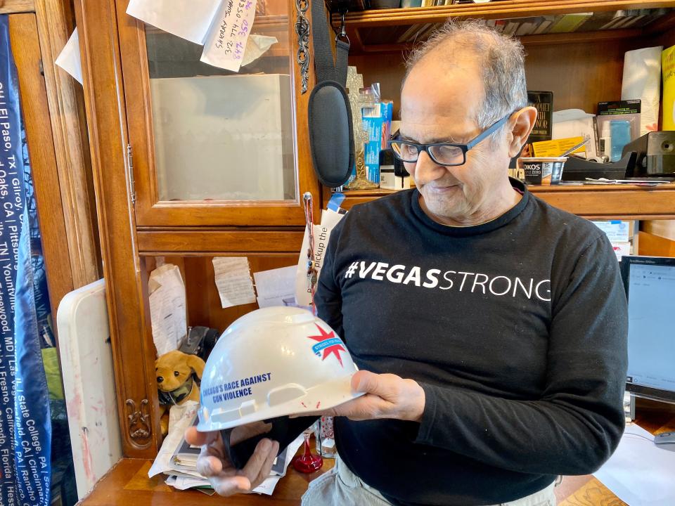 Greg Zanis holds his hard hat in his office in Aurora, Ill. on Feb. 14, 2020.