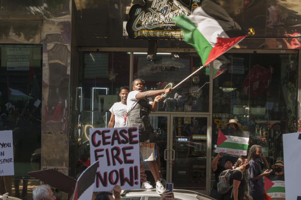People participate during a pro-Palestinian march calling for a ceasefire in Gaza, Saturday, Oct. 21, 2023, downtown Los Angeles. (AP Photo/Damian Dovarganes)