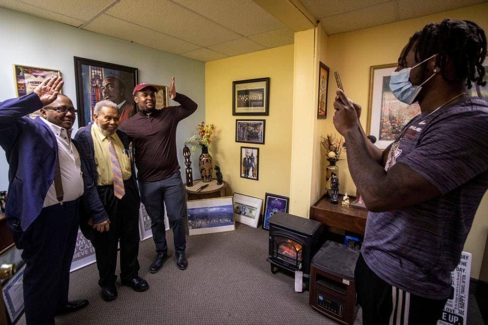 Dr. William Jackson, center left, has his photo taken as he talks with some of his friends who are also Morehouse alums at his office in Detroit, MI on Friday, January 14, 2022. Jackson is a graduate of Morehouse College, the same college Dr. Martin Luther King Jr. attended. Jackson interacted with King and is still currently practicing medicine at age 89.