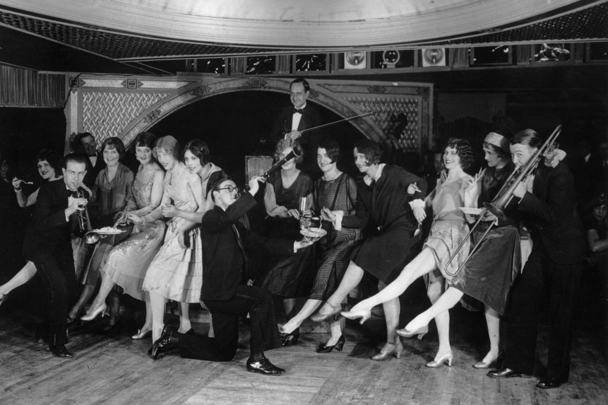 22nd january 1926: female flappers kicking, dancing, and having fun while musicians perform during a charleston dance contest at the parody club