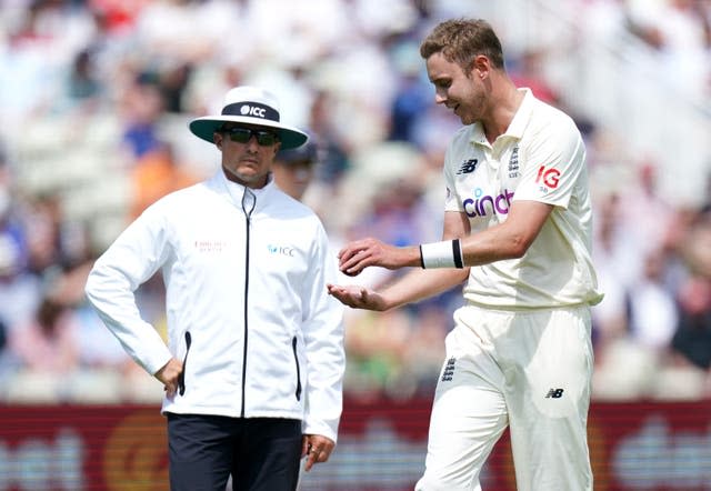 Stuart Broad (right) speaks to the umpires