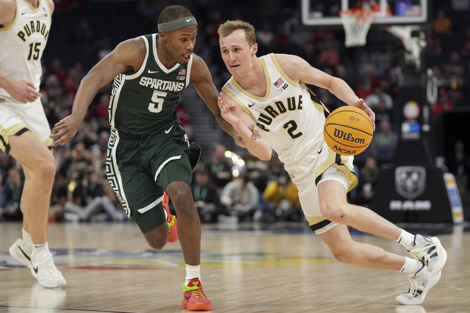 Purdue guard Fletcher Loyer (2) works toward the basket as Michigan State guard Tre Holloman (5) defends during the first half of an NCAA college basketball game in the quarterfinal round of the Big Ten Conference tournament, Friday, March 15, 2024, in Minneapolis. (AP Photo/Abbie Parr)