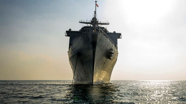 PHOTO: The amphibious dock landing ship USS Harpers Ferry anchors out to sea. (U.S. Navy)