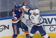 Tampa Bay Lightning center Carter Verhaeghe (23) checks New York Islanders' Devon Toews (25) during the first period of Game 3 of the NHL hockey Eastern Conference final, Friday, Sept. 11, 2020, in Edmonton, Alberta. (Jason Franson/The Canadian Press via AP)