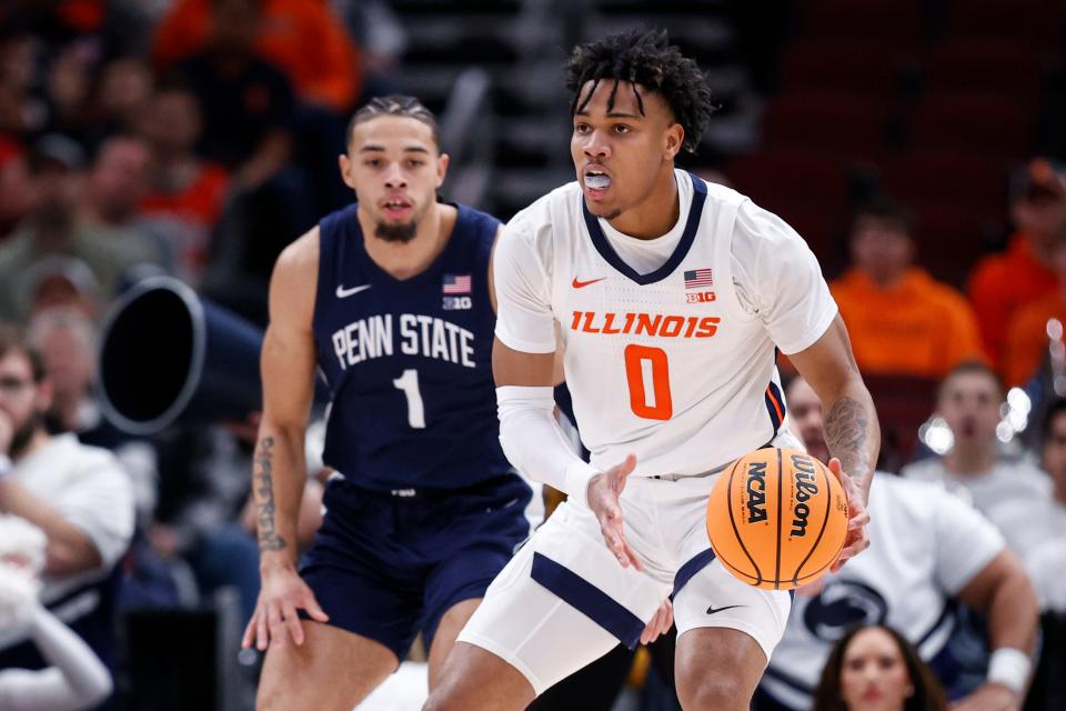 Illinois guard Terrence Shannon Jr. (0) looks to pass the ball while being defended by Penn State guard Seth Lundy (1) during the first half of their 2023 Big Ten tournament game at United Center.