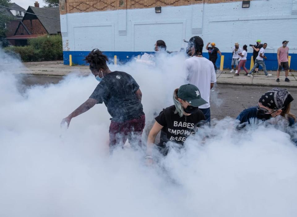 <div class="inline-image__caption"><p>Detroit police use tear gas on protesters following the shooting death of a suspect at the hands of officers last summer.</p></div> <div class="inline-image__credit">Seth Herald/AFP via Getty</div>