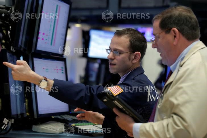 Traders work on the floor of the New York Stock Exchange (NYSE) in New York City, U.S., April 28, 2016. REUTERS/Brendan McDermid