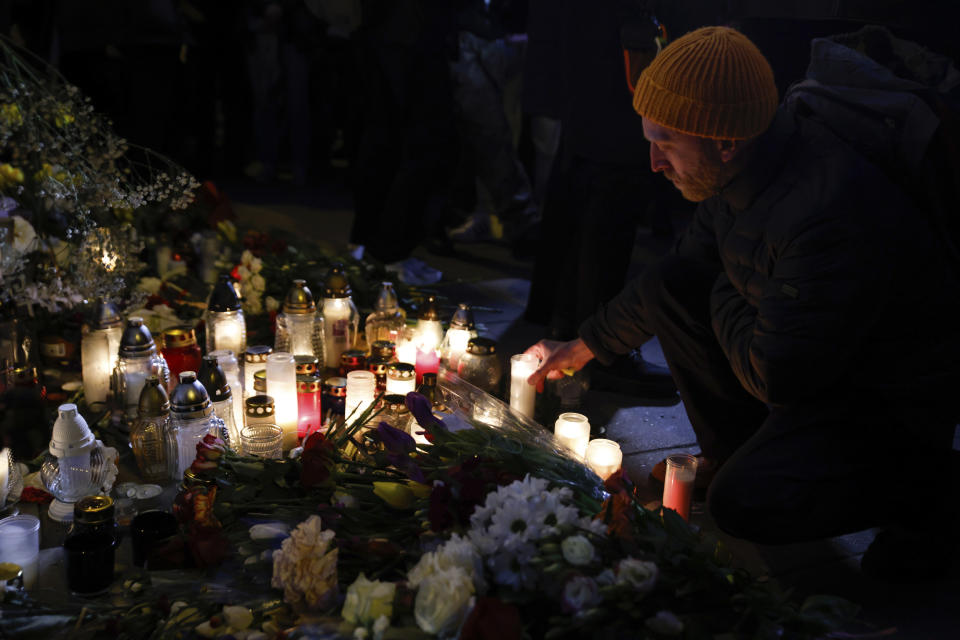 A man lights a candle during a march in silence to commemorate Lizaveta, a 25-year-old Belarusian woman who died after a being brutally attacked and raped on the streets of Warsaw last month, in Warsaw Poland, Wednesday, March 6, 2024. The crime has shocked people across Poland. Poles, Belarusians and Ukrainians gathered at the site of the crime in downtown Warsaw, placing flowers and lighting candles in honor of the woman known only as Lizaveta, or Liza. (AP Photo/Michal Dyjuk)