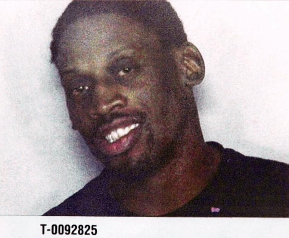 Former basketball star Dennis Rodman is seen here in a police mugshot after he was arrested with actress Carmen Electra Friday, Nov. 5, 1999, by Miami Beach Police after they allegedly fought in a hotel. The couple was release on $2,500 bond after being booked in the Miami-Dade County Jail. (AP Photo)