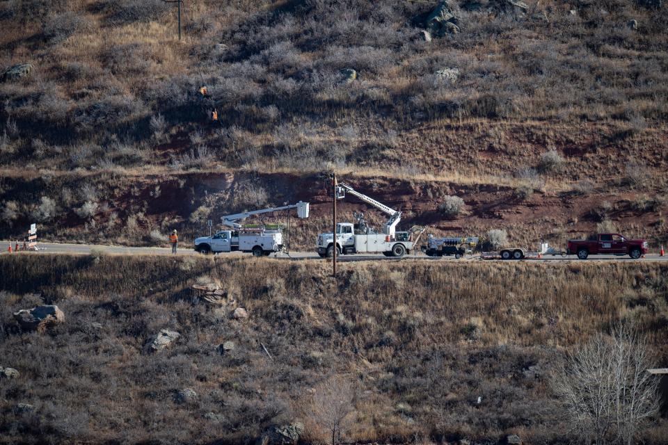 Crews work to fix a down utility line on Thursday, Dec. 16, 2021, along West County Road 38 East near the southeastern edge of Horsetooth Reservoir.