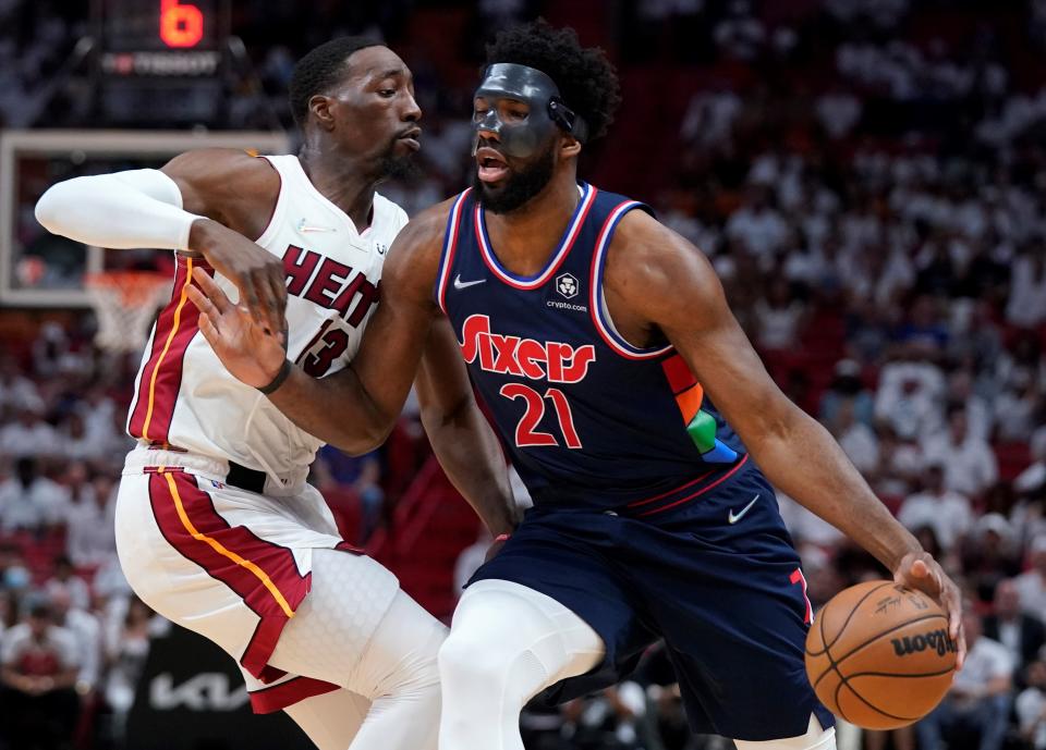 Philadelphia 76ers center Joel Embiid (21) drives up against Miami Heat center Bam Adebayo (13) during the first half of Game 5 of an NBA basketball second-round playoff series, Tuesday, May 10, 2022, in Miami.