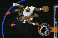 New Orleans Pelicans' James Johnson, right, goes up for a shot against Philadelphia 76ers' Joel Embiid during the second half of an NBA basketball game, Friday, May 7, 2021, in Philadelphia. (AP Photo/Matt Slocum)