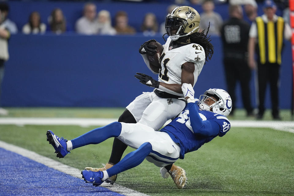 New Orleans Saints running back Alvin Kamara (41) scores on a 16-yard touchdown run as Indianapolis Colts cornerback Jaylon Jones (40) defends during the second half of an NFL football game Sunday, Oct. 29, 2023 in Indianapolis. (AP Photo/Darron Cummings)