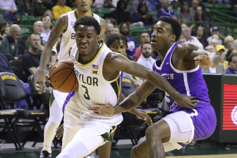 Baylor guard Dale Bonner (3) drives past Tarleton State guard Javontae Hopkins in the first half of an NCAA college basketball game, Tuesday, Dec. 6, 2022, in Waco, Texas. (AP Photo/Rod Aydelotte)