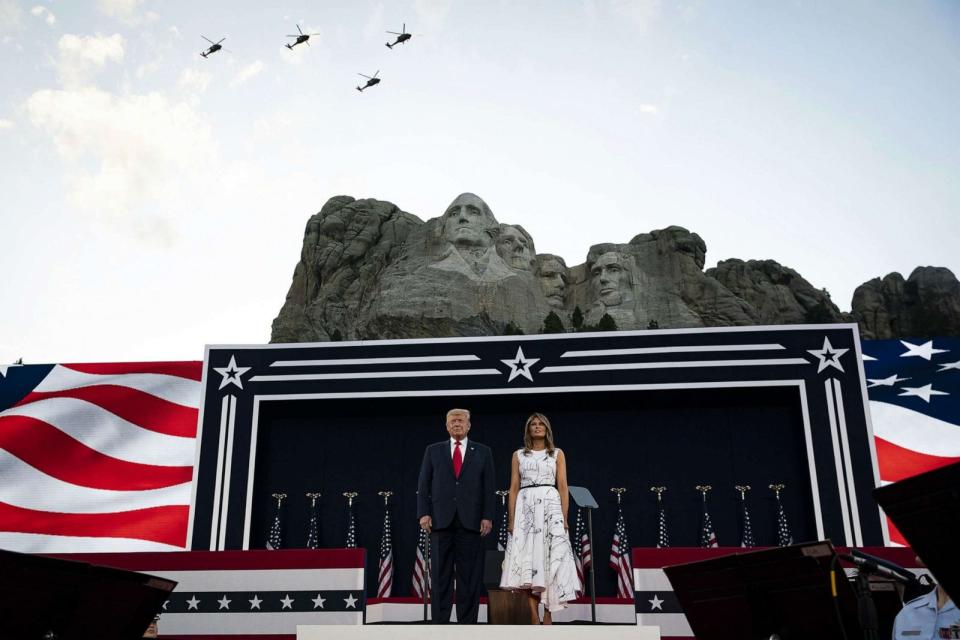 PHOTO: FILE: President Donald Trump and First Lady Melania Trump watch as South Dakota Army National Guard Sikorsky UH-60 Black Hawk helicopters fly over during an event at Mount Rushmore National Memorial in Keystone, S.D., July 3, 2020. (Bloomberg via Getty Images)